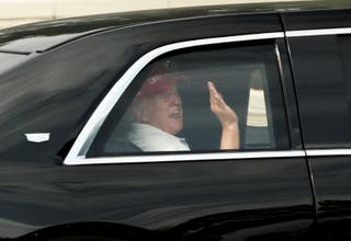 President Donald Trump shakes to supporters while his Golf course department at West Palm Beach